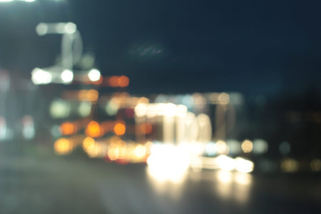 Blurred bokeh of car in city at night