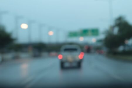 Blurred bokeh of car in city at nightの写真素材