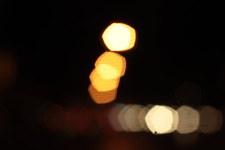 Blurred bokeh of car in city at night