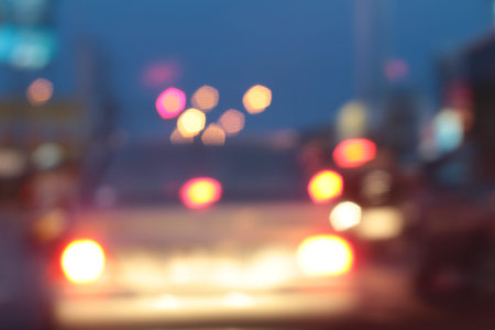 Blurred bokeh of car in city at night