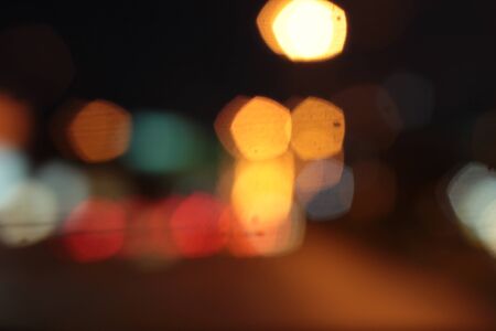 Blurred bokeh of car in city at nightの写真素材
