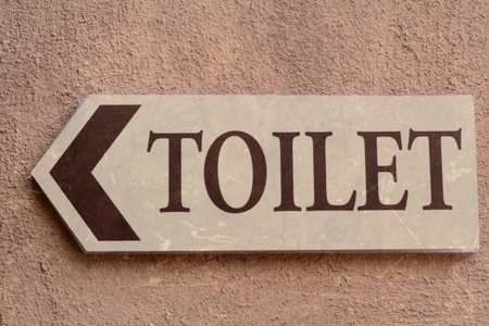 Symbolize toilets on wall backgroundの写真素材