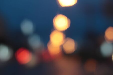 Blurred bokeh of car in city at nightの写真素材
