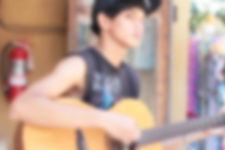 blureed men playing the guitar