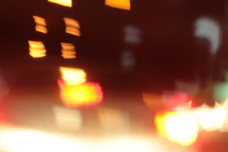 Blurred bokeh of car in city at nightの写真素材