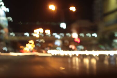 Blurred bokeh of car in city at nightの写真素材