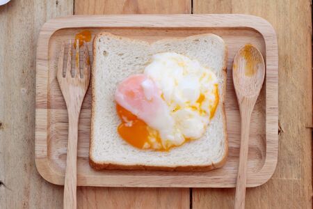 soft-boiled egg with bread on wood background.の写真素材