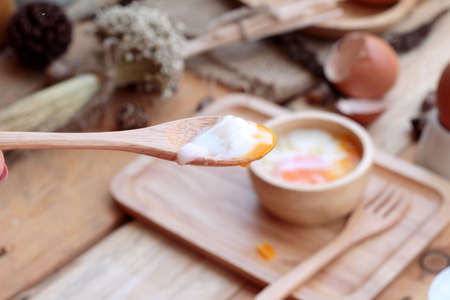 soft-boiled egg and eggs on wood backgroundの写真素材