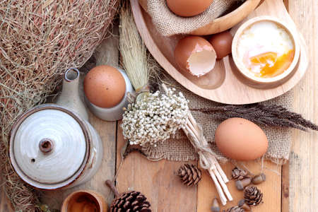 soft-boiled egg and eggs on wood backgroundの写真素材
