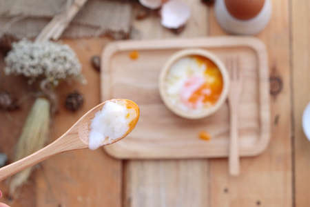 soft-boiled egg and eggs on wood backgroundの写真素材