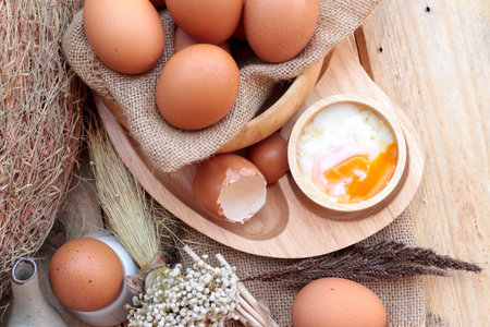 soft-boiled egg and eggs on wood background