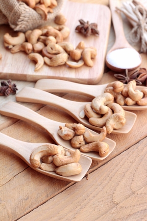 Roasted cashews nuts with natural on wood backgroundの写真素材