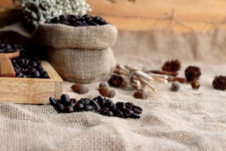 Roasted coffee beans on sack brown background.の写真素材
