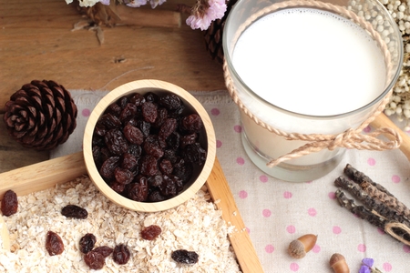 Oat flakes with currant dried fruit and milkの写真素材