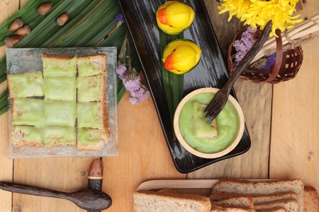 Bread with green custard and fresh milkの写真素材