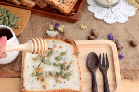 Brown bread with whole grain cereals of sliced and milkの写真素材