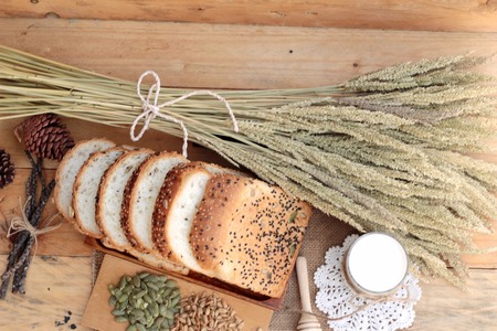 Brown bread with whole grain cereals of sliced and milkの写真素材