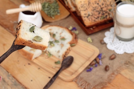 Brown bread with whole grain cereals of sliced and milkの写真素材
