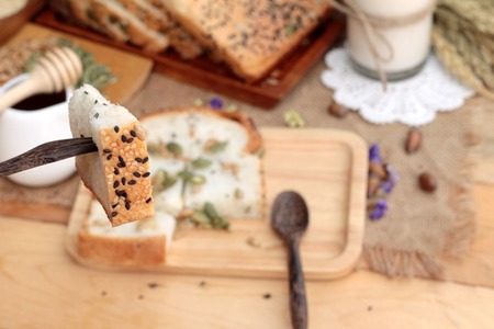 Brown bread with whole grain cereals of sliced and milkの写真素材