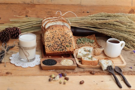 Brown bread with whole grain cereals of sliced and milkの写真素材
