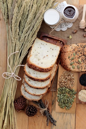 Brown bread with whole grain cereals of sliced and milkの写真素材