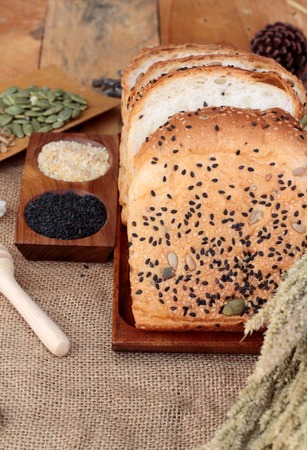 Brown bread with whole grain cereals of sliced and milkの写真素材