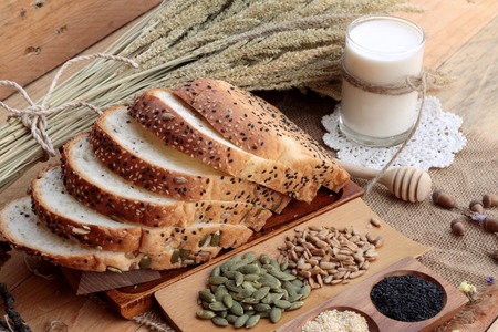 Brown bread with whole grain cereals of sliced and milkの写真素材