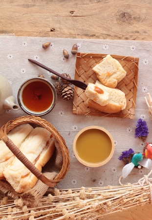Bread with milk tea custard and hot teaの写真素材