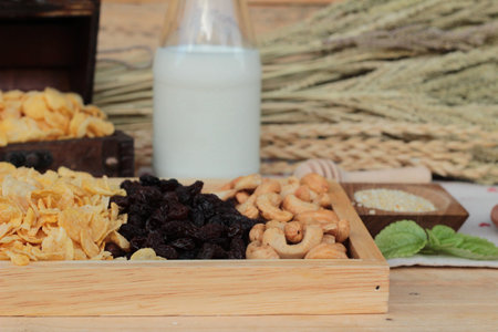 Corn flake with currant dried fruit ,cashew nuts and milkの写真素材