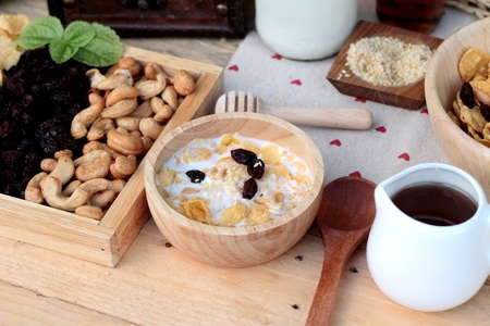 Corn flake with currant dried fruit ,cashew nuts and milkの写真素材