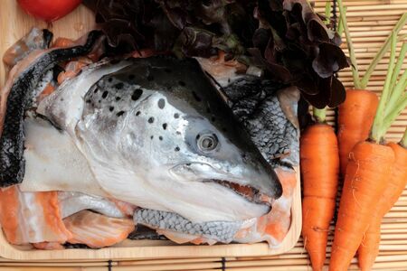 Salmon head and salt , pepper for cookingの写真素材