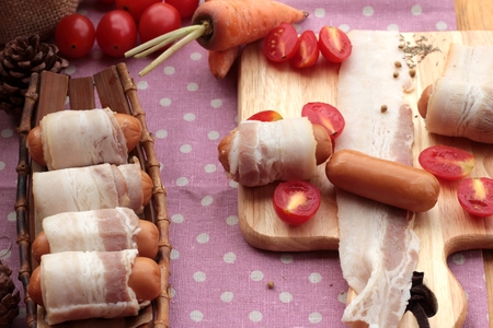 Sausages  wrapped in raw bacon fat at deliciousの写真素材