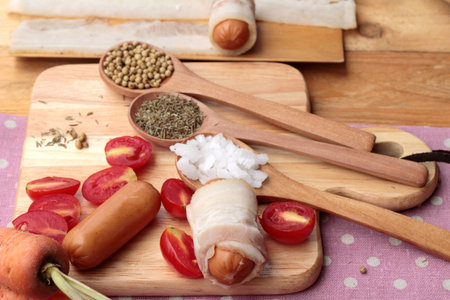 Sausages  wrapped in raw bacon fat at deliciousの写真素材