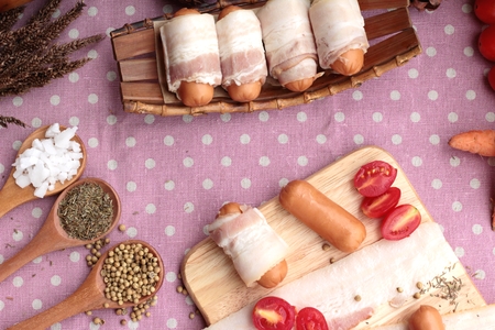 Sausages  wrapped in raw bacon fat at deliciousの写真素材