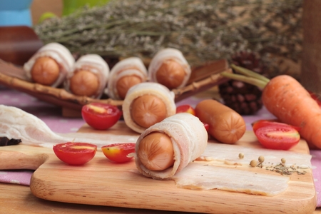 Sausages  wrapped in raw bacon fat at deliciousの写真素材