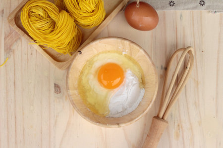 Making yellow noodle with egg and wheat flour