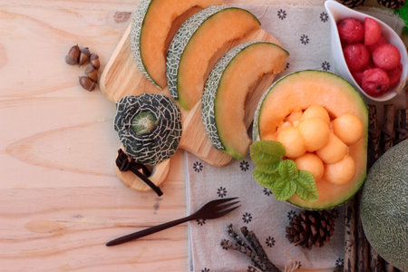 Orange cantaloupe melon fruit juicy on wood backgroundの写真素材