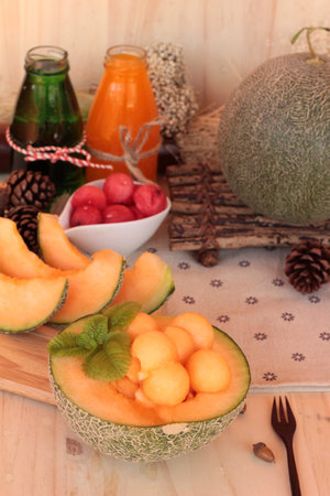 Orange cantaloupe melon fruit juicy on wood background