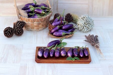Purple eggplants fresh for cooking on wood backgroundの写真素材
