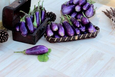 Purple eggplants fresh for cooking on wood backgroundの写真素材
