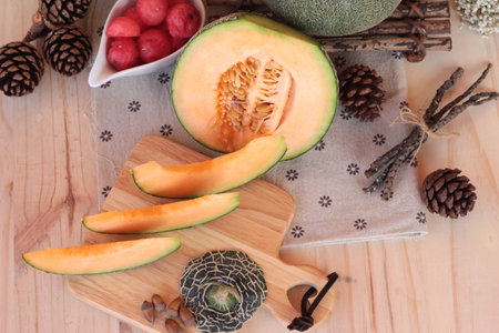 Orange cantaloupe melon fruit juicy on wood backgroundの写真素材