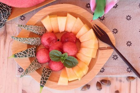 Orange cantaloupe melon fruit juicy on wood backgroundの写真素材