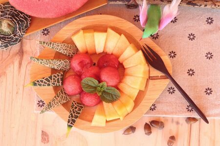 Orange cantaloupe melon fruit juicy on wood backgroundの写真素材