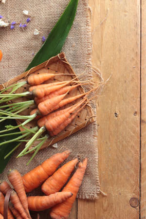 Fresh carrots on the wood backgroundの写真素材