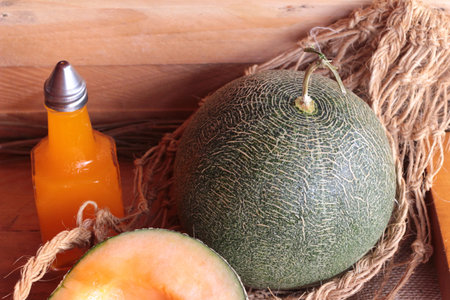 Orange cantaloupe melon fruit juicy on wood background