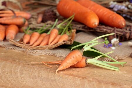 Fresh carrots on the wood backgroundの写真素材