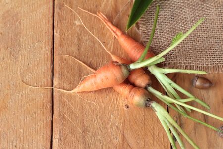 Fresh carrots on the wood backgroundの写真素材