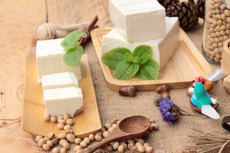 Tofu and soybeans on wood background