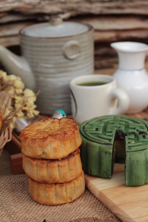 Festival moon cake - china dessert with green teaの写真素材