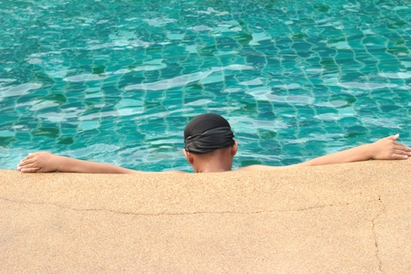A boy swimming in the poolの写真素材